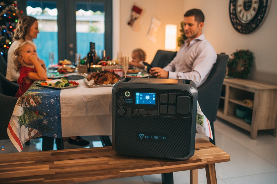 family members celebrate christmas with solar-powered generator