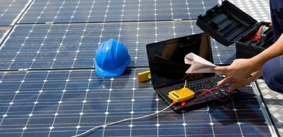 healthy and safety inspectors looking at solar panels 