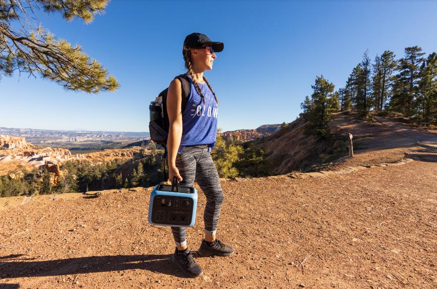 woman carrying a portable solar generator